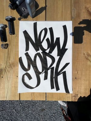 Marker on white poster. Text: "New York."